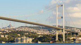 Zoom out daytime timelapse of cars crossing the Bosphorus Bridge and boats navigating the Bosphorus Strait in Istanbul, Turkey. 4k at 24fps