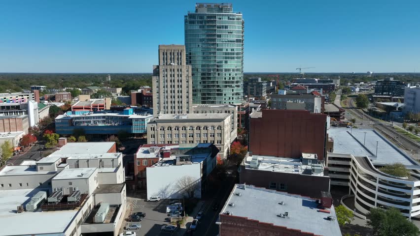 Modern USA city skyline. Aerial tilt up towards glass skyscraper.