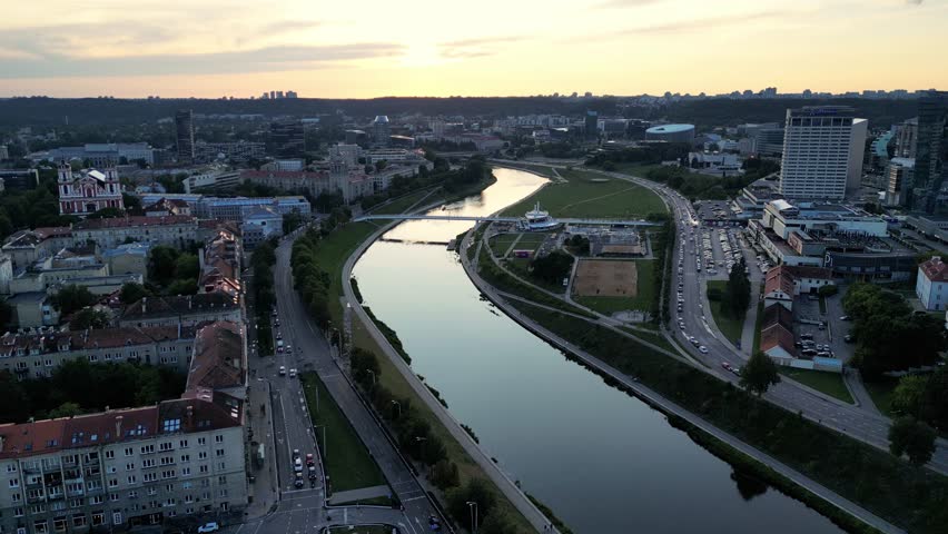 Aerial View Of The Neris River, Drone Flies Forward Over The River, Vilnius City Forest Park, Beautiful Summer Nature. Beautiful Aerial View Of The Old Town Of Vilnius, The Capital Of Lithuania. Royalty-Free Stock Footage #3427126267