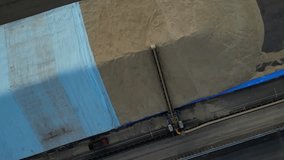 Grain unloading for distribution industry. Aerial top-down orbiting