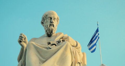 Marble statue of the Greek philosopher Plato background of Greek architecture in slow motion.