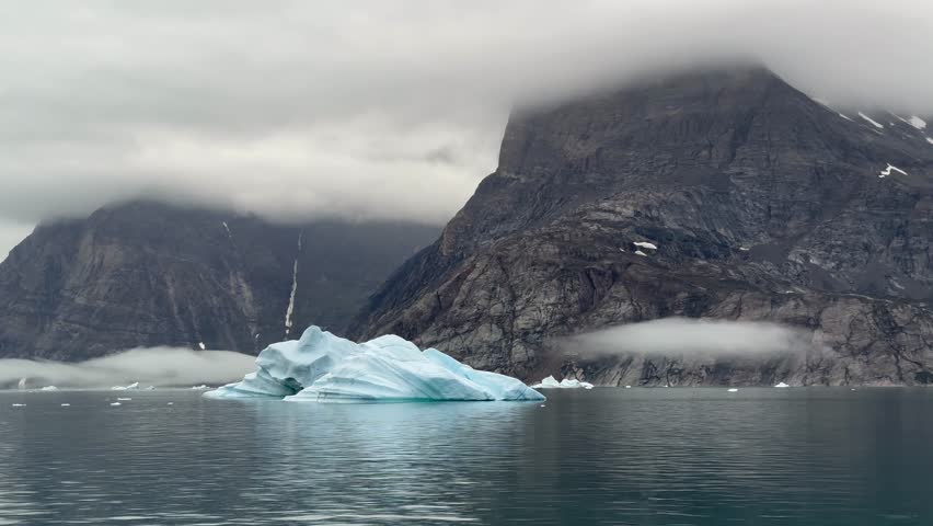 Small iceberg drifting by in Ø Fjord. Scoresbysund, Greenland.