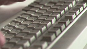 Computer engineer developer is working on old vintage computer 1990s. Antique classic pc keyboard and programmer typing hands. Internet web digital startup history. Outdated retro technology concept - Powered by Shutterstock - Get 15% off with code: PIKWIZARD15