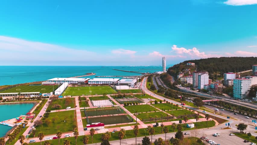 View of the beach, sports complex, astroturf field, hotel and port taken with a drone on a sunny day in Samsun Batıpark. V2  Samsun, Türkiye