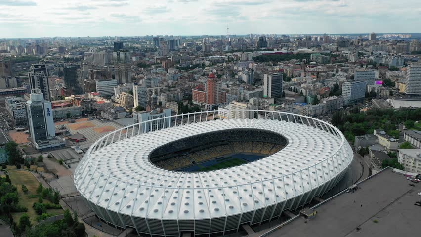 Stadium. cityscape time of day night. The view from the top to the illuminated stadium with games and fans. Stadium, Kiev, Ukraine, Olympic Stadium.