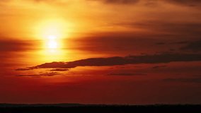 Amazing sunset in orange sky with soft clouds, Timelapse. 4K. Bright sun setting down above the horizon. Dramatic colorful dark sunset epic clouds. Vibrant color. Time-lapse. Sundown, Cloudscape - Powered by Shutterstock - Get 15% off with code: PIKWIZARD15