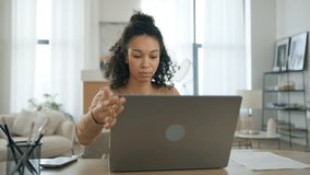 Pleasant biracial woman closing laptop and leaving work deck at the end of work day. Multi ethnic businesswoman finishing project in living room. Remote employee work from home concept slow motion - Powered by Shutterstock - Get 15% off with code: PIKWIZARD15