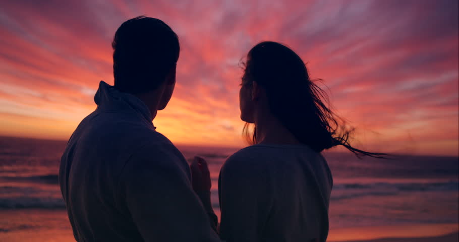 Silhouette, beach and couple at sunset kiss for bonding, together and relationship by ocean. Dating, nature and man and woman with affection and love for romance on holiday, vacation and weekend Royalty-Free Stock Footage #3427350249