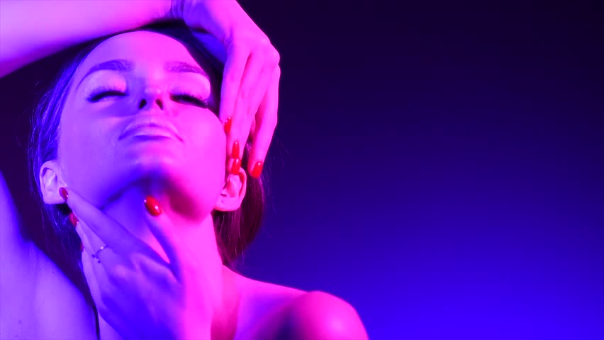 Colorful portrait of beauty sexy model girl. Beautiful seductive woman posing. Gorgeous Brunette girl in neon light. Beauty Glamour sensual lady posing in vivid lights 