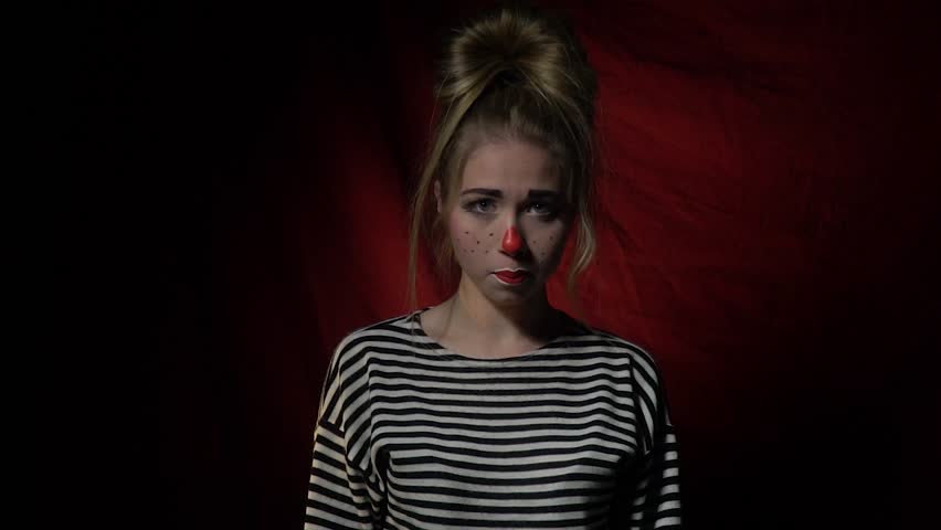 Sad girl clown coming up and laughing