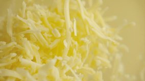 Heap grated cheddar cheese flying in slow motion close up. Shredded yellow parmesan cheese falling in macro - Powered by Shutterstock - Get 15% off with code: PIKWIZARD15