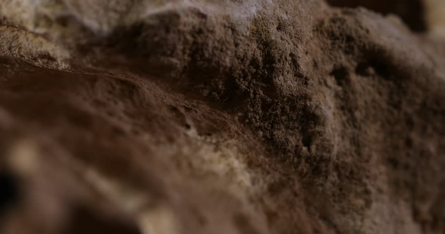 Rock Stone texture close-up. Rought mountain surface. Geological sample. Wall in cave. Macro shot natural mineral background. 