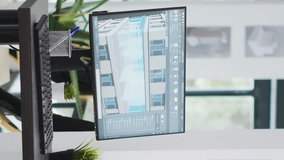 Vertical Video Creative agency office empty desk with pc running cad software, manufacturing floor plans and blueprints placed on design table. Architectural coworking space filled with modern