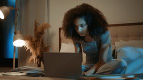 African American 20s girl high school student learning at home writing notes homework on bed late night online studying with laptop distant education young woman listen webinar on computer e-learning - Powered by Shutterstock - Get 15% off with code: PIKWIZARD15