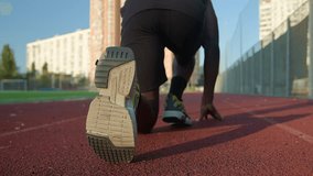 Low start position back view runner African American man guy sportsman preparing ready starting on running track male runner jogger run marathon active sport training outdoors jogging at city sunlight - Powered by Shutterstock - Get 15% off with code: PIKWIZARD15