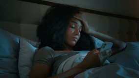 African American girl scrolling smartphone mobile phone online apps in bed before sleeping upset shocked ethnic woman customer worried internet problem loss connection error mistake bad news rejection - Powered by Shutterstock - Get 15% off with code: PIKWIZARD15