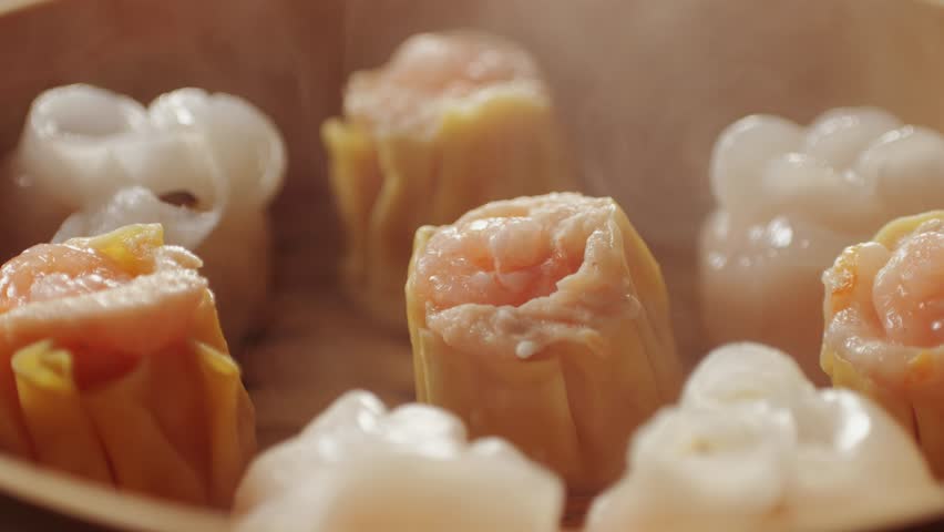 Various of dim sum on wooden steamer close-up macro. Steaming Technique. Chinese dessert food. Dimsum with shrimps, fish and meat. Dish in a cafe. Homade. Delivery