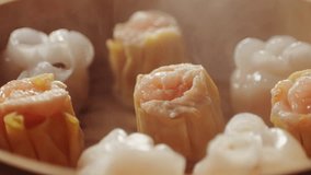 Various of dim sum on wooden steamer close-up macro. Steaming Technique. Chinese dessert food. Dimsum with shrimps, fish and meat. Dish in a cafe. Homade. Delivery - Powered by Shutterstock - Get 15% off with code: PIKWIZARD15