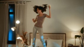 Happy crazy ethnic girl rich African American woman female dancing on bed in night evening bedroom having fun music at home throwing money dollars cash wealthy prize salary luxury dream lot of finance - Powered by Shutterstock - Get 15% off with code: PIKWIZARD15