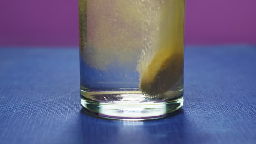  Effervescent tablet vitamin C nutritional supplements in glass with orange carbonated water.Aspirin antipyretic drugs.Vitamins C pills against flu, medicines. Healthy concept immune system