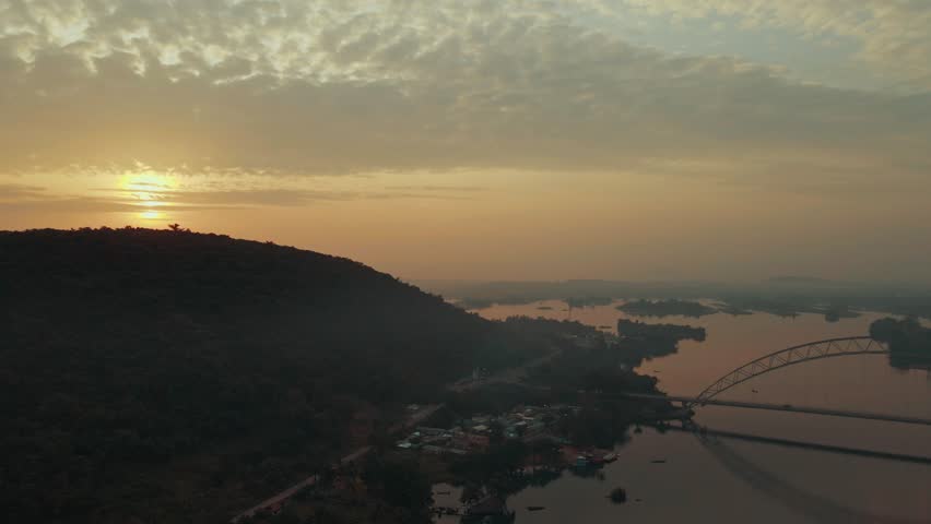 Dolly drone shot of the Adomi bridge and mountain in the neighborhood of Akosombo Atimpoku, Eatern Region