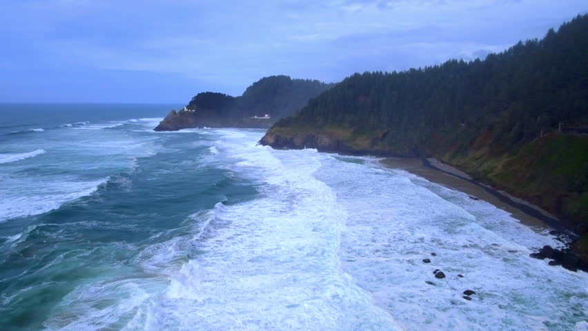 Aerial Backward Scenic Shot Of Wavy Sea By Hiking Trail Under Clouds - Shore Acres, Oregon