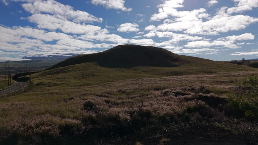 Hawaii big island hill revealing valley with clouds