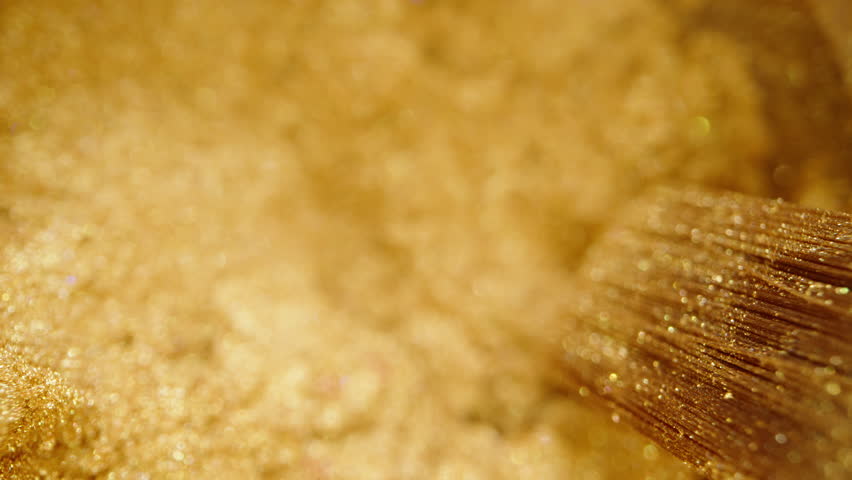 Golden edible powder with a brush for decorating pastries. Dolly slider extreme close-up.