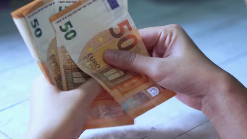 Closeup of hands counting euro money bills, european economy value. Cash money calculation. A stack of euro banknotes in hands. concept of savings banks, banking, paying taxes and money circulation. Royalty-Free Stock Footage #3427596513
