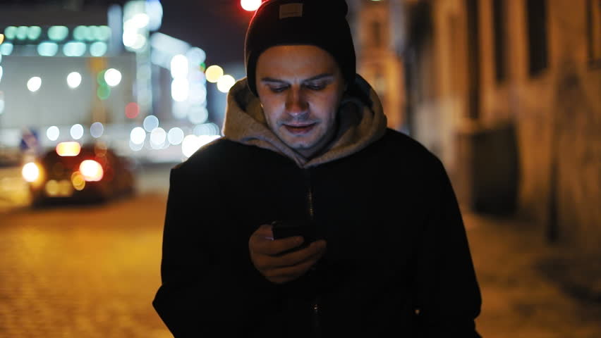 Man sms texting using app smart phone walking night city lights handsome young businessman smartphone outdoors urban male glare modern technology internet connecting 3G chatting online message map gps