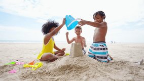 Happy Children travel playing at the sea on summer beach holiday vacation. Group of Little cute child boy and girl kids enjoy and fun outdoor lifestyle playing beach toy build sand castle on the beach - Powered by Shutterstock - Get 15% off with code: PIKWIZARD15