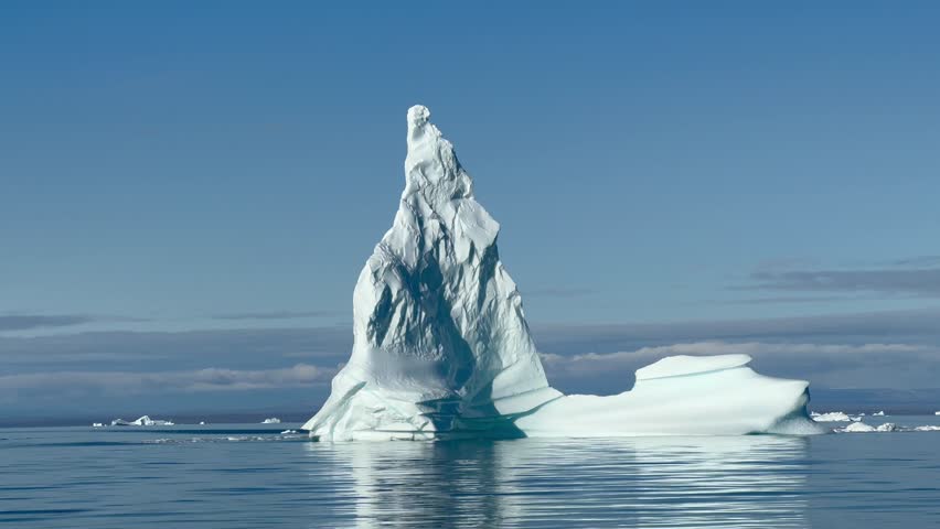 View of lonely iceberg in Hall Bredning. Scoresbysund, Greenland. Royalty-Free Stock Footage #3427753657
