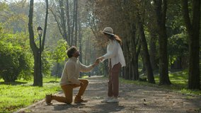 Multiethnic couple in love african american man indian woman loving guy make marriage proposal to beloved girl put ring on finger in park outdoors he proposed she accepted accepting hug hugging happy - Powered by Shutterstock - Get 15% off with code: PIKWIZARD15