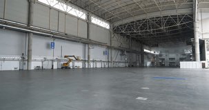 Large empty warehouse, huge premise. Cinema 4K 60fps tilt view video