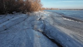 ice on the river. walk on the frozen river. a man walks on snow and ice. dangerous ice. freezing water. deep cracks in the ice. winter sunny landscape with a river. winter river and sun. - Powered by Shutterstock - Get 15% off with code: PIKWIZARD15