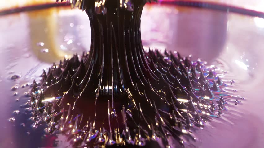 Ferromagnetic fluid. Real ferromagnetic fluid in action. Viscous ferrofluid spike-like shape. Ferromagnetic fluid creates amazing drawings spikes in magnetic field, appearing and disappearing Royalty-Free Stock Footage #3427841923