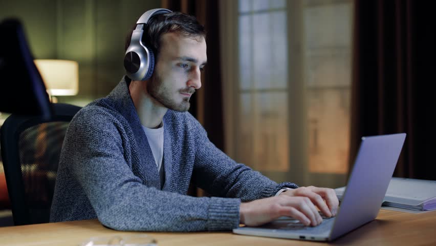Focused young man doing e-commerce work on laptop. Professional male working, search information on internet, ponders looks concentrated, thoughtful engaged in workflow on-line. Royalty-Free Stock Footage #3427846445