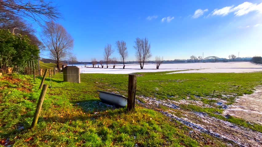 Dutch pictoresque landscape at floodplain covered in snow during winter