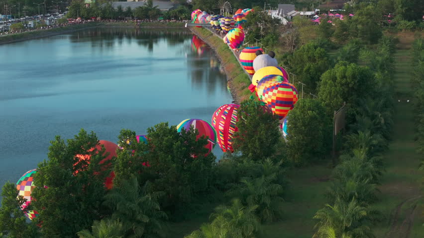 Colorful hot air balloon children figures in line in sunset on Khao Lak festival