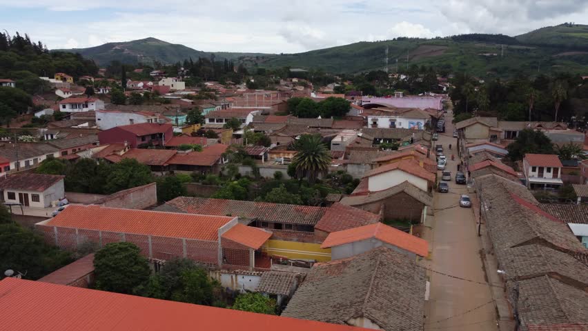 Aerial: Clay tile rooftops in quaint Bolivian mountain town, Samaipata