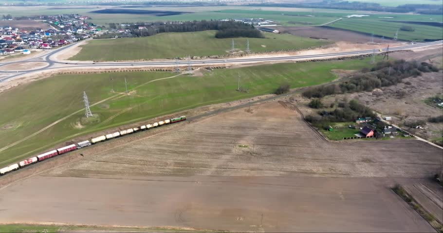 aerial view of railway with moving train with carriages