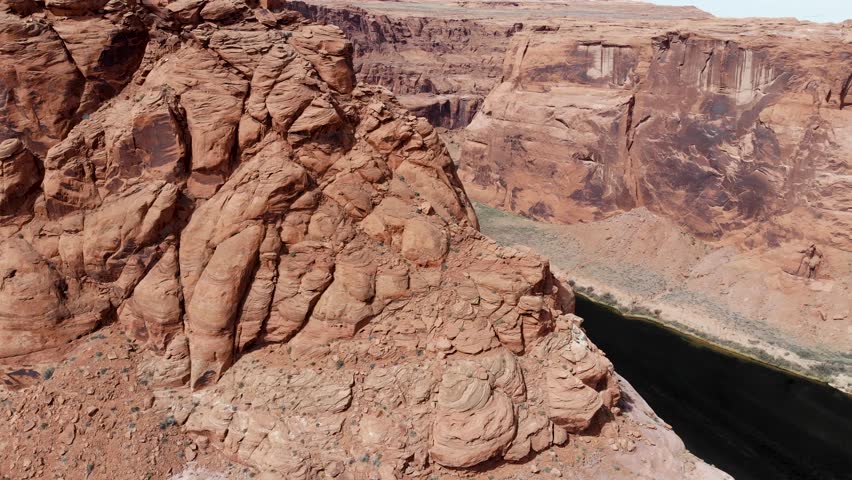 A 4K drone shot over Horseshoe Bend, the “east rim of the Grand Canyon”, located near the town of Page, Arizona. The camera starts low in the canyon and rises up over, revealing the meandering river.
