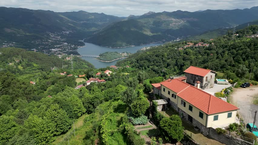 erial View of Homes in Gerês National Park, Portugal, Overlooking Caniçada Dam on a Clear Day, Parque Nacional Peneda-Gerês