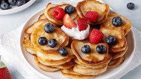 Homemade mini pancakes with blueberries, strawberries and raspberries.
