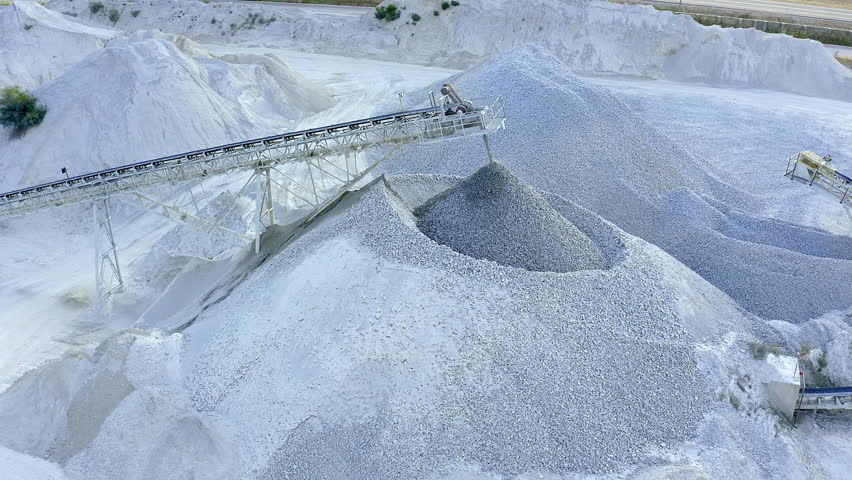 Sand mining, machinery and drone for natural resources, digging and engineering for mineral extraction. Labour, cranes or conveyer belt for geology, industrial and equipment for outdoor production