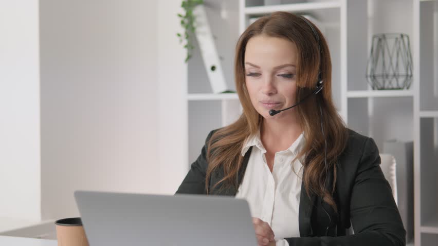 A satisfied female call center operator working remotely gives customers a smile and excellent service. Her warm communication and efficiency create an enjoyable experience for every customer. - Powered by Shutterstock - Get 15% off with code: PIKWIZARD15