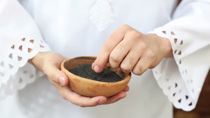 Priest holding a bowl of ashes during Ash Wednesday celebration.  Royalty-Free Stock Footage #3428204283
