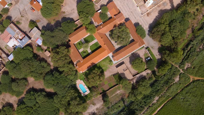 Top down drone shot flying over the small town of Molinos in Salta, Argentina.