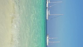 Beautiful sea beach with white sand and boats in the bay, Thailand. Vertical video