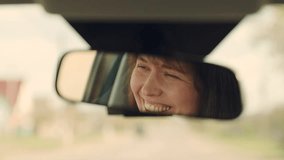 Girl driver drives her car, happy emotions. Beautiful young woman traveling by car, smiling, rejoicing, good mood. Young female driver in reflection of rearview mirror. Weekend, car, road, sports - Powered by Shutterstock - Get 15% off with code: PIKWIZARD15